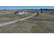 Well-maintained horse barn and fenced riding area, ideal for equestrian enthusiasts, in a rural setting at 1465 Arabian Trl, Elizabeth, CO 80107