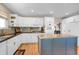 Well-equipped kitchen featuring white cabinets, an island with seating, and stainless steel appliances at 1465 Arabian Trl, Elizabeth, CO 80107