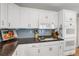 Bright kitchen features stainless appliances, white cabinetry, gas cooktop, and hardwood floors at 1465 Arabian Trl, Elizabeth, CO 80107
