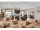 Comfortable living room with a fireplace, modern decor, and an open floor plan with access to the dining area at 1465 Arabian Trl, Elizabeth, CO 80107