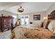 Bedroom features ornate furniture, ceiling fan, balcony access, and hardwood floors at 1465 Arabian Trl, Elizabeth, CO 80107
