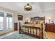 Bedroom features an ornate wood bed frame, ceiling fan, bedside tables and natural light at 1465 Arabian Trl, Elizabeth, CO 80107