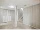 Finished basement featuring painted paneling, column, access to staircase, and large storage closet at 3274 S Heather Gardens Way, Aurora, CO 80014