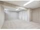 Finished basement area with carpeted floors, paneled walls, and two closets with bi-fold doors at 3274 S Heather Gardens Way, Aurora, CO 80014