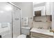 Clean bathroom with tiled walk-in shower, vanity, and medicine cabinet at 3274 S Heather Gardens Way, Aurora, CO 80014