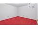 Empty bedroom with bright red carpeting and single window providing natural light at 3274 S Heather Gardens Way, Aurora, CO 80014