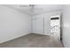 Bright bedroom with sliding closet, neutral walls, grey carpet, and a window providing natural light at 3274 S Heather Gardens Way, Aurora, CO 80014