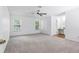 Spacious main bedroom with light grey carpet, ceiling fan, and ensuite bathroom at 3274 S Heather Gardens Way, Aurora, CO 80014