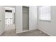 Bright bedroom with sliding closet, neutral walls, grey carpet, and a window providing natural light at 3274 S Heather Gardens Way, Aurora, CO 80014