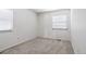 Cozy bedroom with two windows offering natural light, neutral walls, and grey carpet at 3274 S Heather Gardens Way, Aurora, CO 80014
