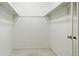 Empty walk-in closet with shelving and a neutral carpet at 3274 S Heather Gardens Way, Aurora, CO 80014