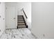 Hallway with marble tile flooring leads to upper level staircase at 3274 S Heather Gardens Way, Aurora, CO 80014