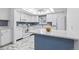 Contemporary kitchen with white appliances, cabinets, a marble counter, and blue accents at 3274 S Heather Gardens Way, Aurora, CO 80014
