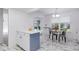 Eat-in kitchen boasts marble tile floors, white cabinets, peninsula island, and backyard views at 3274 S Heather Gardens Way, Aurora, CO 80014