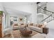 Bright living room features neutral decor, staircase, and opens to the kitchen for easy entertaining at 3274 S Heather Gardens Way, Aurora, CO 80014
