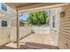 Covered paver patio with white fencing provides a cozy outdoor retreat at 3274 S Heather Gardens Way, Aurora, CO 80014