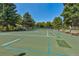 A community tennis court is surrounded by mature trees and has plenty of seating for players and spectators at 3274 S Heather Gardens Way, Aurora, CO 80014