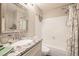 Bathroom with granite vanity, large mirror, and shower-tub combination at 9467 W Ontario Dr, Littleton, CO 80128