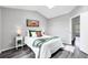 Bright bedroom featuring vaulted ceiling, skylight, and hardwood floors at 9467 W Ontario Dr, Littleton, CO 80128
