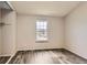 Bedroom with modern flooring, neutral walls, large window with mountain view, and closet at 9467 W Ontario Dr, Littleton, CO 80128