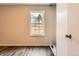 Bedroom featuring hardwood floors, a window, and neutral wall color at 9467 W Ontario Dr, Littleton, CO 80128
