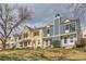 Street view showcasing colorful townhomes with well-maintained lawns and a cloudy sky at 9467 W Ontario Dr, Littleton, CO 80128