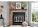 Close up of a stone fireplace with wooden mantle and decorative accents at 9467 W Ontario Dr, Littleton, CO 80128