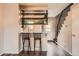 Open floor plan with kitchen featuring bar seating, wooden shelving, and updated cabinets and fixtures at 9467 W Ontario Dr, Littleton, CO 80128