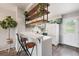 Charming kitchen with quartz countertops, stainless steel appliances, and open shelving at 9467 W Ontario Dr, Littleton, CO 80128