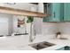 Close up of kitchen showcasing stainless steel sink and quartz countertops with pass through to living area at 9467 W Ontario Dr, Littleton, CO 80128