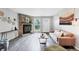 Inviting living room showcasing a stone fireplace, hardwood floors, and ample natural light at 9467 W Ontario Dr, Littleton, CO 80128
