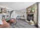 Cozy living room featuring a stone fireplace, hardwood floors, and modern decor at 9467 W Ontario Dr, Littleton, CO 80128
