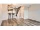 Bright living room with modern flooring, staircase, and updated shelving at 9467 W Ontario Dr, Littleton, CO 80128