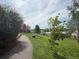 Scenic community pathway with lush greenery and mature trees at 9467 W Ontario Dr, Littleton, CO 80128
