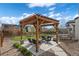Landscaped backyard with pergola, string lights, seating area, fire pit, and a trampoline at 228 Horizon Ave, Erie, CO 80516