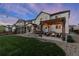 Spacious backyard featuring a pergola-covered patio with seating around a fire pit and string lights at 228 Horizon Ave, Erie, CO 80516