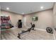 Basement fitness and game area featuring a basketball game, arcade game, and rowing machine at 228 Horizon Ave, Erie, CO 80516