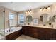 Luxurious bathroom showcasing a relaxing soaking tub, dual vanities, and elegant fixtures at 228 Horizon Ave, Erie, CO 80516