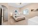 Cozy bedroom featuring a queen bed, plush bedding, modern lighting and bright natural light at 228 Horizon Ave, Erie, CO 80516