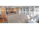 Spacious bonus room with an open floor plan, stylish built-in shelving, and comfortable seating area at 228 Horizon Ave, Erie, CO 80516