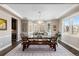 Bright dining room featuring hardwood floors, large windows, and a modern chandelier at 228 Horizon Ave, Erie, CO 80516