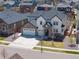 Beautiful two-story home showcasing a three-car garage and a well-maintained, landscaped front yard at 228 Horizon Ave, Erie, CO 80516