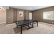 Spacious game room with ping pong table, neutral tones, and a door to the hallway at 228 Horizon Ave, Erie, CO 80516