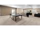 Finished basement game room features ping pong table, a comfy sectional, and a wall mounted tv at 228 Horizon Ave, Erie, CO 80516