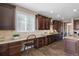 Gourmet kitchen with custom cabinetry, granite counters, and a built-in desk area at 228 Horizon Ave, Erie, CO 80516