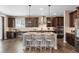 Well-appointed kitchen features a center island with seating, stainless steel appliances, and wood floors at 228 Horizon Ave, Erie, CO 80516