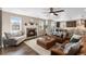 Bright, open-concept living room with fireplace, comfortable seating, and kitchen in view at 228 Horizon Ave, Erie, CO 80516