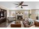 Comfortable living room features a stone fireplace, plush seating, and natural light at 228 Horizon Ave, Erie, CO 80516