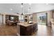 Open concept living room featuring hardwood floors, kitchen island, and a cozy fireplace at 228 Horizon Ave, Erie, CO 80516