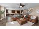 Spacious living room with hardwood floors, comfortable leather seating, and an open floor plan at 228 Horizon Ave, Erie, CO 80516